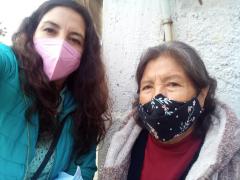 Araceli Vega en la entrada de la casa junto a la persona entrevistada.