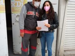 Araceli Vega y Mark Esquivel en la entrada de la casa de la persona entrevistada.