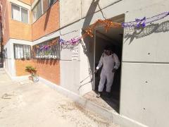 Hombre sanitiza afueras de edificio. Fotografía: Facebook Alcaldía Iztapalapa.