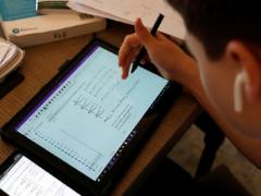 Fotografía de alumno utilizando una tablet.