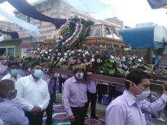 Hombres cargan el Santo Entierro. Algunos llevan cubrebocas morados con su rostro. Fotografía: Periódico Econsulta Tlaxcala.